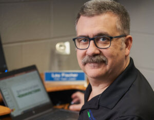 Male office worker smiling at desk